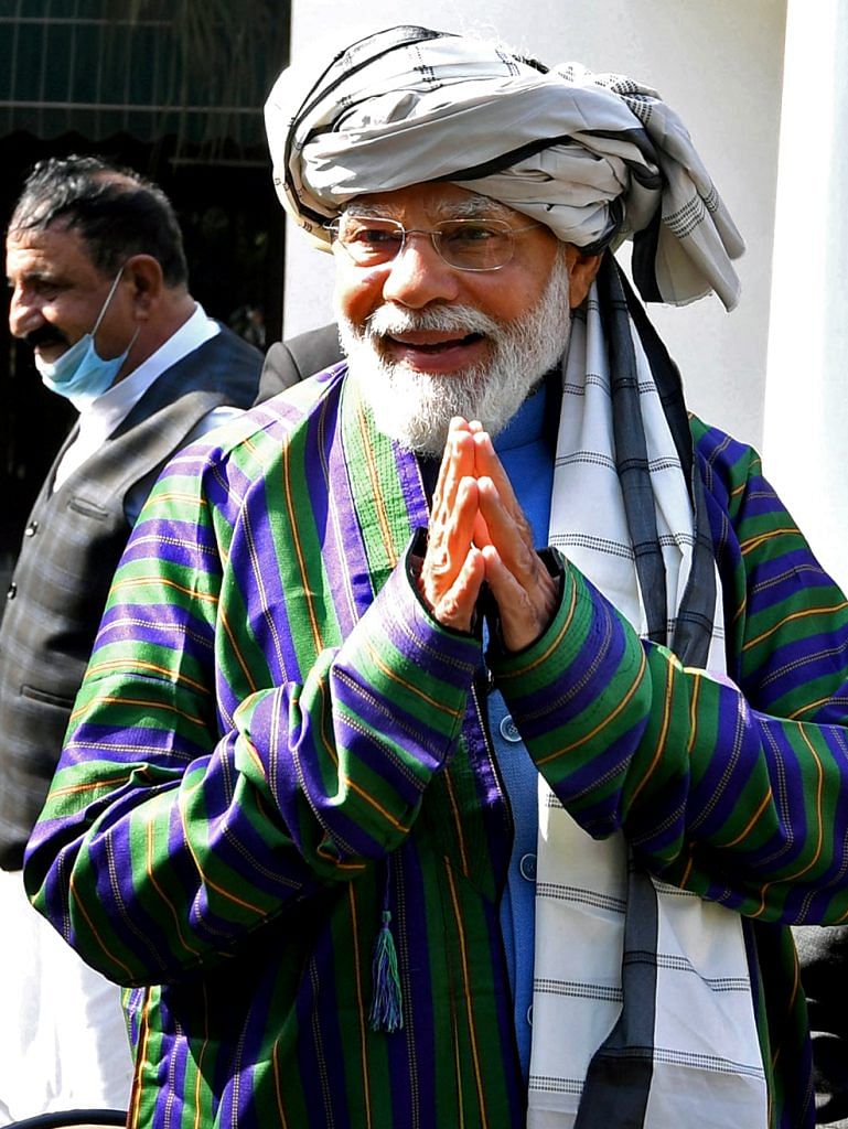 Prime Minister Narendra Modi greets while meeting the Afghan Hindu-Sikh delegation, at his residence, Lok Kalyan Marg, in New Delhi. 19 Feb 2022.