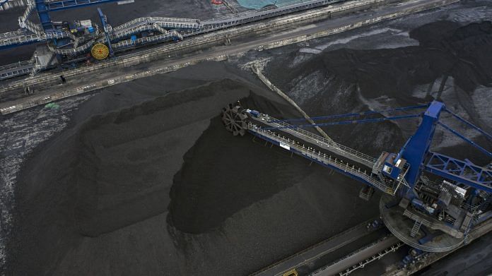 A stacker-reclaimer operates at a coal stockpile site in Taicang, Jiangsu Province, China | Photo: Qilai Shen | Bloomberg File