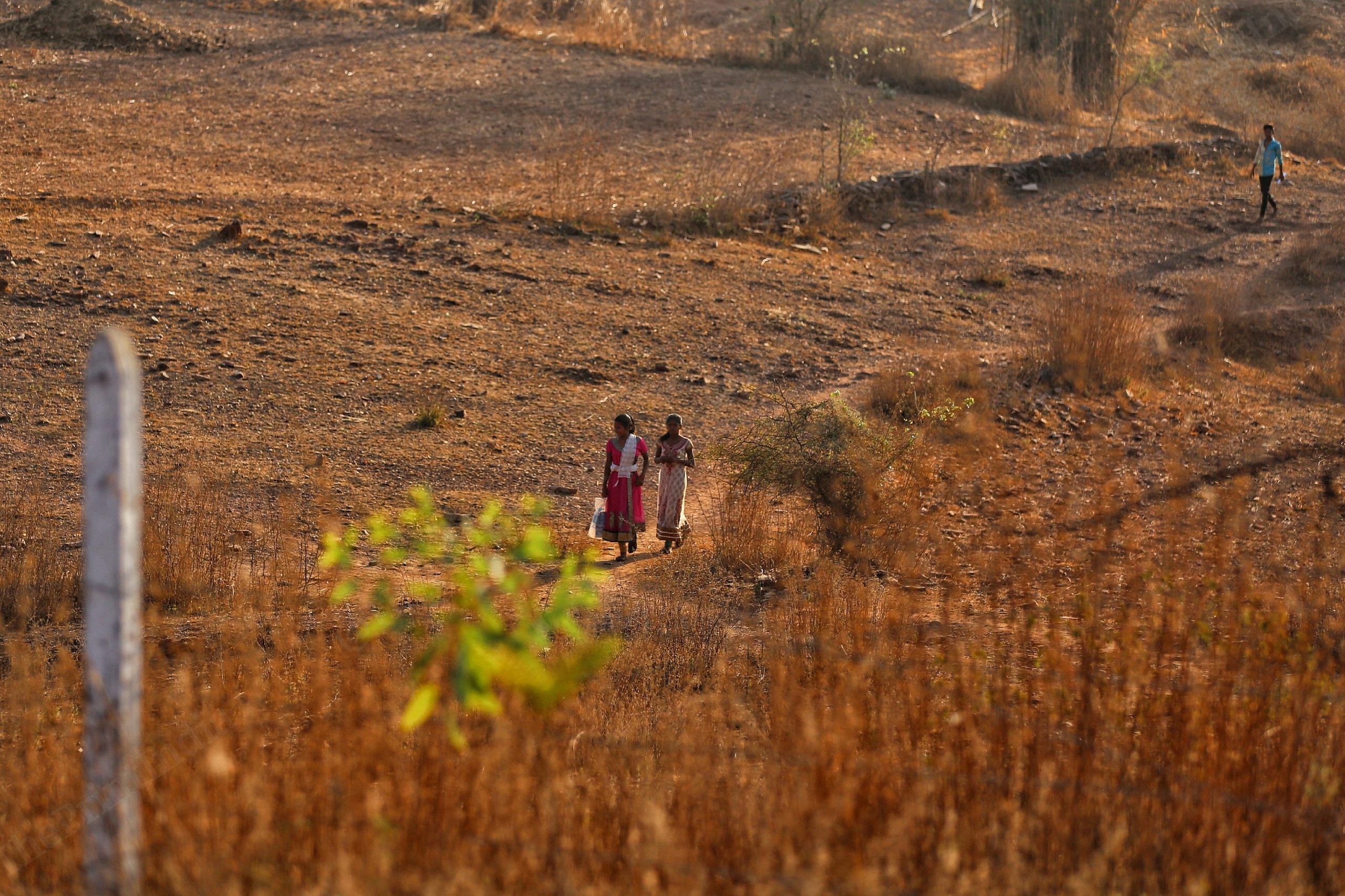 Two girls walk to school across stretches of the Aravalli hills| Photo: Manisha Mondal | ThePrint