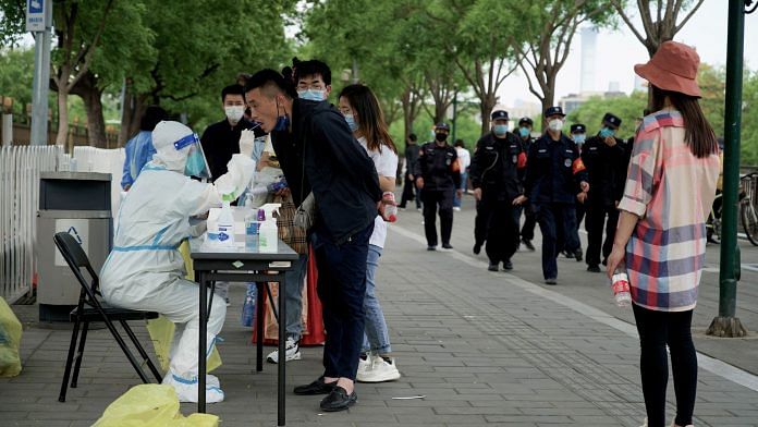 A man undergoes a test for Covid-19 in Beijing on 1 May 2022