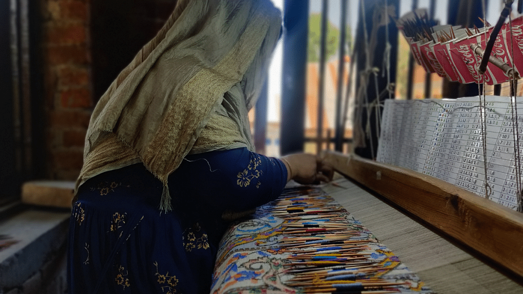 A worker makes Pashmina 'kaani shawls', the wooden spool is called a Kaani, hence the name 'Kaani shawl', showing how Kashmiri carpet making is gradually taken over; photo by Shubhangi Misra | ThePrint