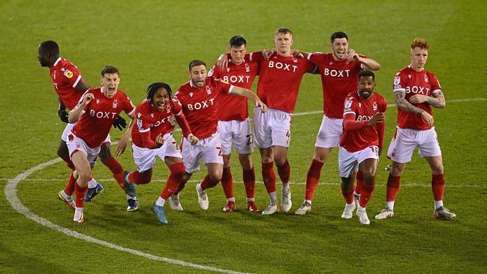 The Notts Forest team celebrate winning the penalty shoot out during the Sky Bet Championship Play-Off match between Nottingham Forest and Sheffield United at City Ground on 17 May 2022 in Nottingham, England | Photo by Michael Regan | Getty Images via Bloomberg