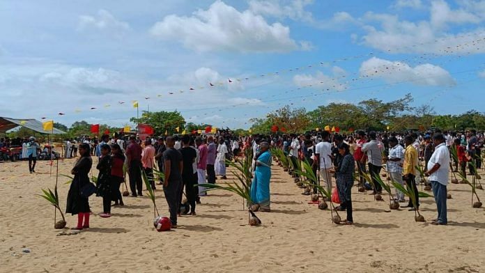 People line up in front of the memorial flame in Mullivaikkal | Photo: Sowmiya Ashok | ThePrint