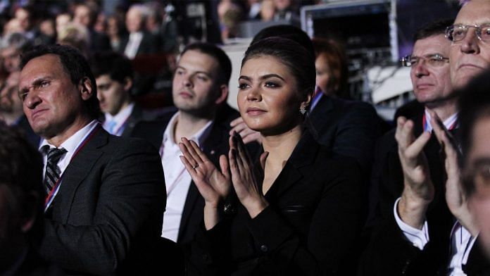 Russian politician & former Olympic Champion, Alina Kabaeva, applauds as President Vladimir Putin (not pictured) delivers his speech in Moscow | File image | Photo via Bloomberg