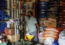 A shopkeeper arranges stock at a grocery store in Bengaluru | Representational image | Bloomberg Photo