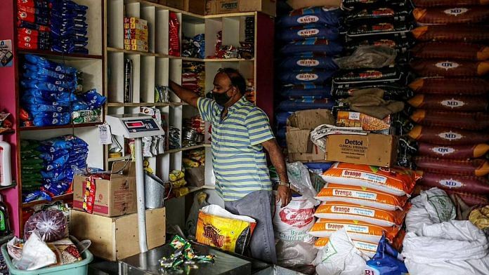 A shopkeeper arranges stock at a grocery store in Bengaluru | Representational image | Bloomberg Photo