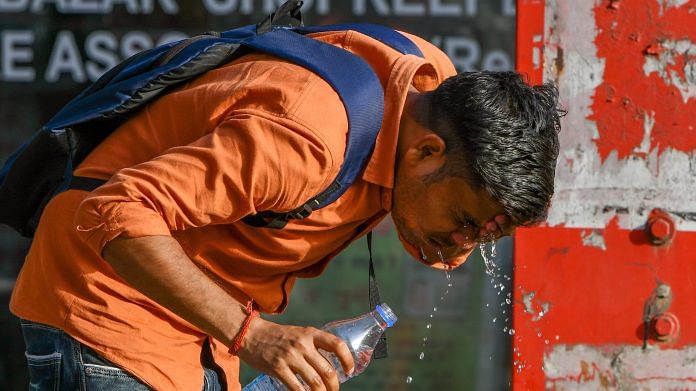 A man splashes water on his face on a summer day, in New Delhi | ANI Photo