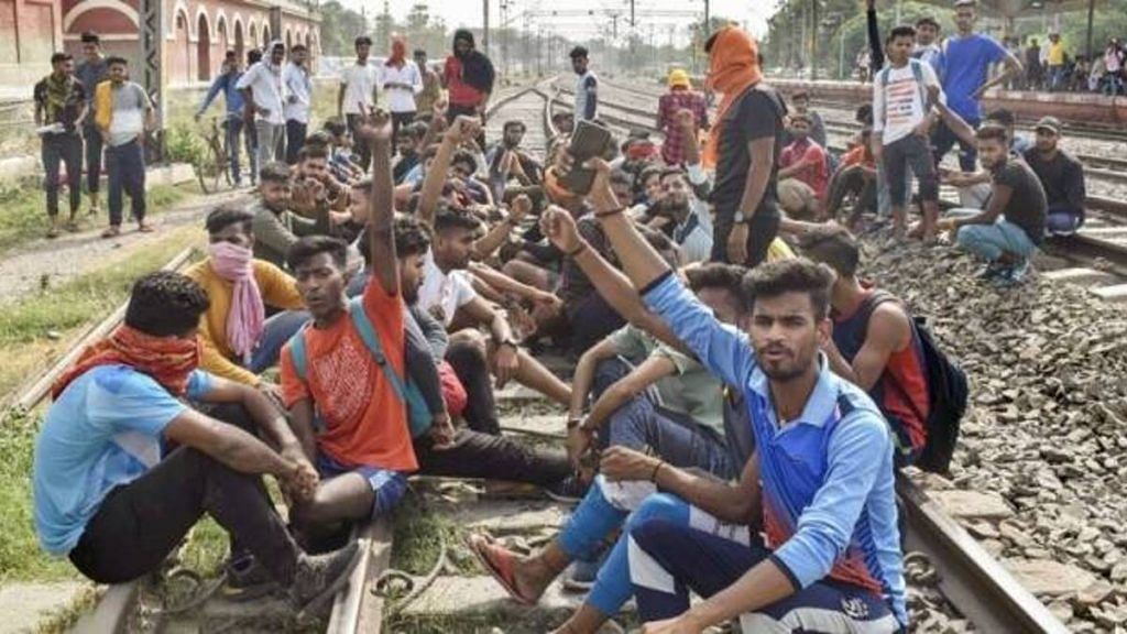 Youngsters sit on railway tracks in Bihar to protest against the Agnipath scheme | PTI