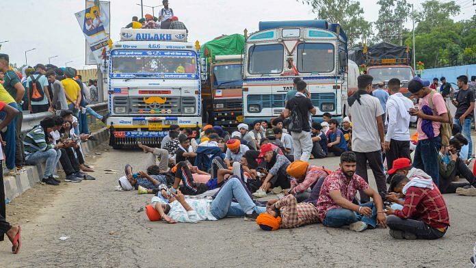 People block Jalandhar-Delhi National Highway to protest against Centre's 'Agnipath' scheme, in Jalandhar on 18 June 2022 | PTI Photo
