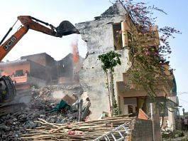 A bulldozer demolishing a house in Prayagraj on Sunday | ANI