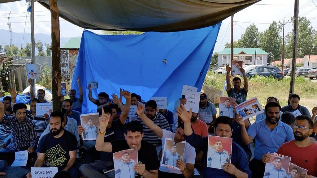 Kashmiri Pandits protesting inside Anantnag's Vessu camp. Some are holding up a photo of Rahul Bhat, who was killed by terrorists on 12 May | Sajid Ali | ThePrint
