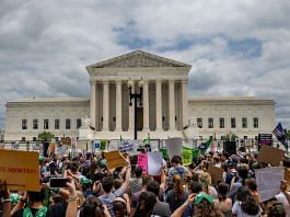 People protest in response to the Dobbs v Jackson Women's Health Organization ruling in front of the US Supreme Court, 24 June 2022 | Photo by Brandon Bell/Getty Images via Bloomberg