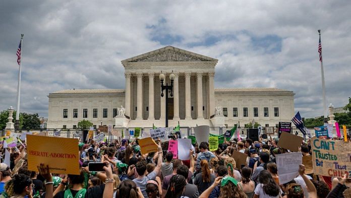People protest in response to the Dobbs v Jackson Women's Health Organization ruling in front of the US Supreme Court, 24 June 2022 | Photo by Brandon Bell/Getty Images via Bloomberg