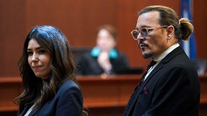 US actor Johnny Depp stands next to his lawyer Camille Vasquez after a break in the defamation trial against ex-wife Amber Heard at the Fairfax County Circuit Courthouse in Fairfax, Virginia | Photographer: Kevin Lamarque/AFP/Getty Images via Bloomberg