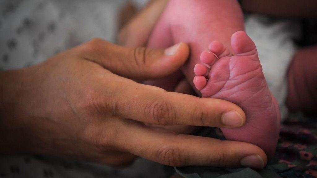 A mother holds the foot of her newborn baby | Representational image | Photographer: Loic Venance/AFP/Getty Images via Bloomberg