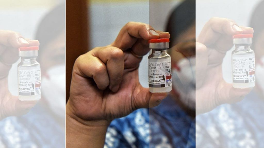 A healthcare worker in New Delhi holds up a bottle of the Corbevax Covid vaccine, for the 12-14 age group, at a vaccination centre | ANI Photo