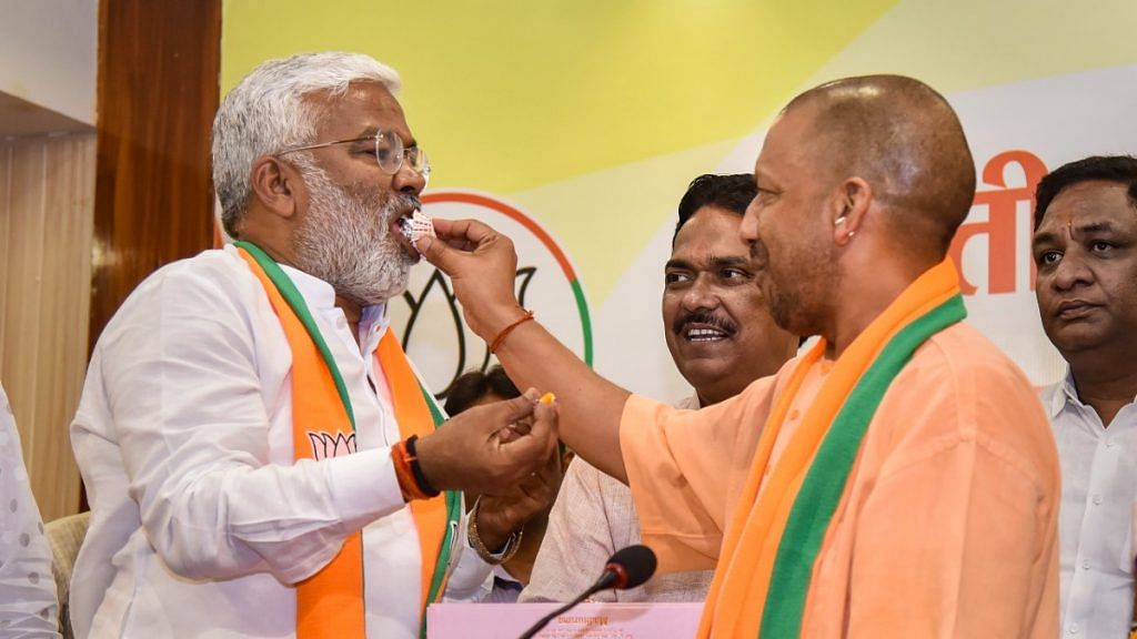 Uttar Pradesh Chief Minister Yogi Adityanath and UP BJP president Swatantra Dev Singh celebrate the party’s bypoll victories in Lucknow Sunday | PTI