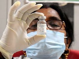 Representational image of a healthcare worker showing a vial of Covaxin | ANI
