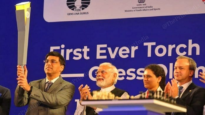 Five-time world chess champion Viswanathan Anand hold the torch as Prime Minister Narendra Modi looks on, at the at the Indira Gandhi Stadium in Delhi Sunday | Praveen Jain | ThePrint