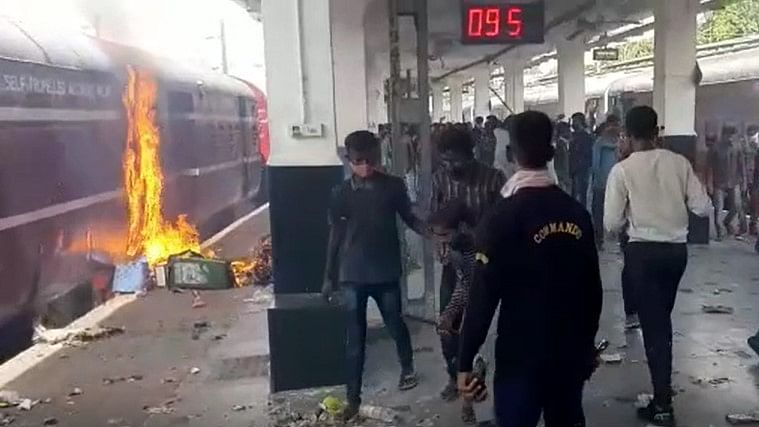 Protesters try to set a train boogie on fire at Secunderabad Railway station in Hyderabad on 17 June 2022