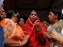Kanhaiya Lal Teli's wife Yashoda (in red) being comforted by others | Photo: Manisha Mondal | ThePrint