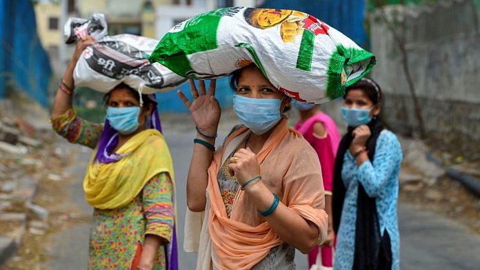 File photo of women with free ration collected from a fair price shop during the Covid lockdown | PTI