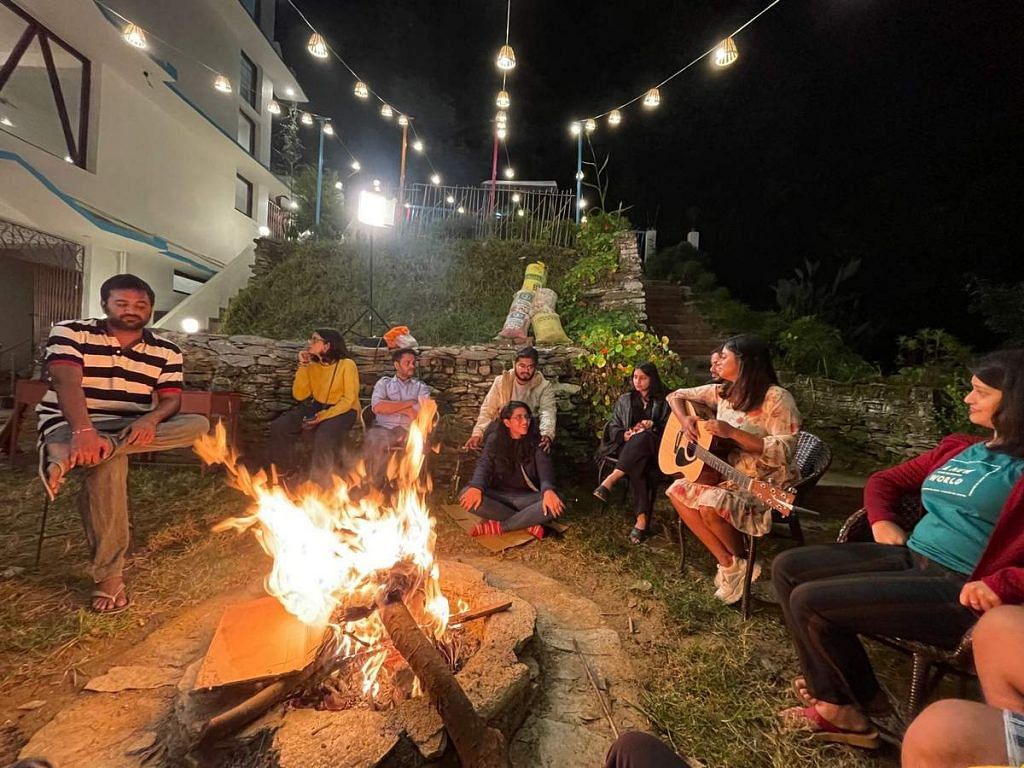 Young travellers bond over a bonfire at a goSTOPS hostel in Nainital | By special arrangement