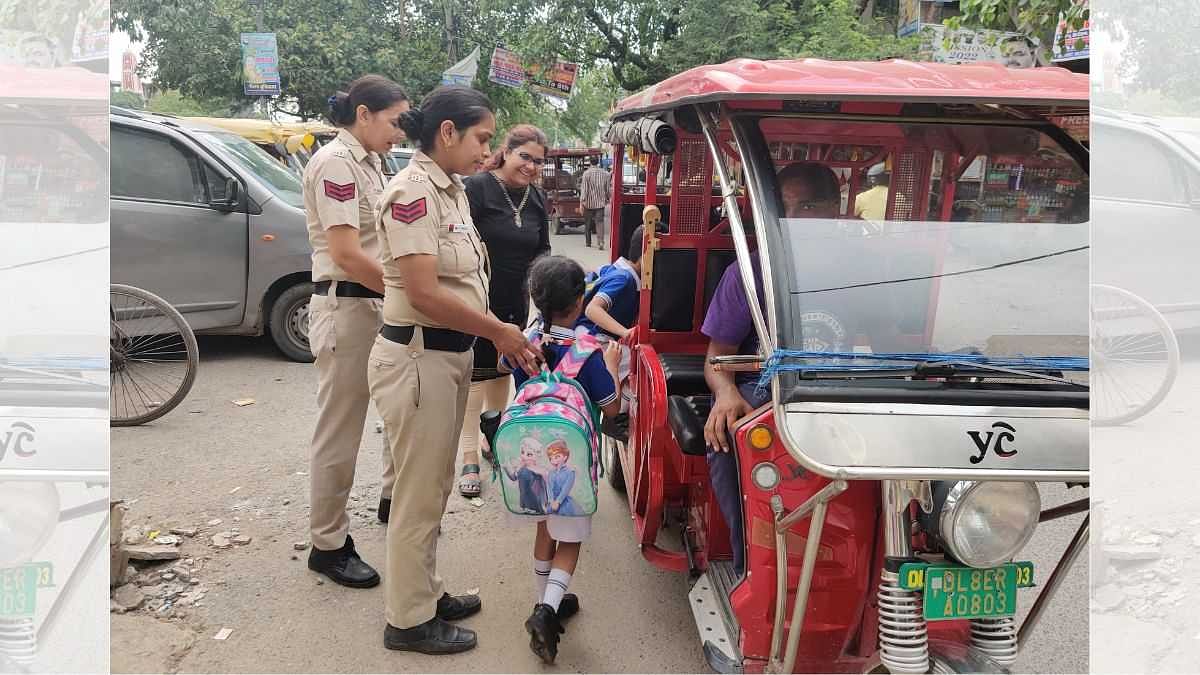 Head Constables Anuradha Chaudhary and Vandana Dubey help children on to vehicles after school | Credit: Bismee Taskin, ThePrint 