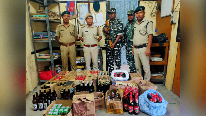 Police with liquor bottles after the bust | ANI Twitter