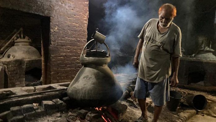 An elderly worker looks at the copper 'deg' used for steaming herbs for preparation of traditional Kannauj attar | Shikha Salaria | ThePrint