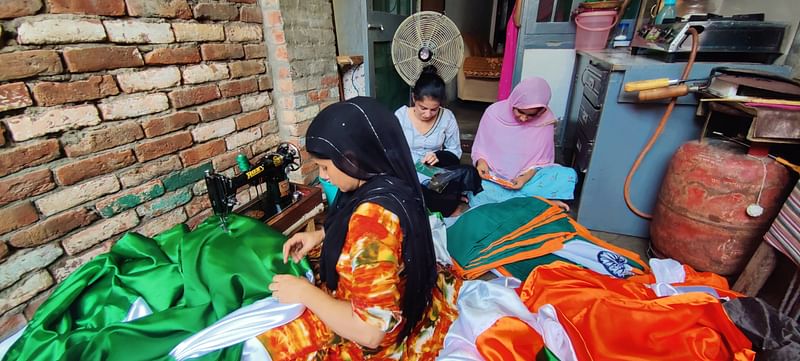 Nahida Noor along with other women stitching tricolor on the veranda of Noor's house. | Chitvan Vinayak | ThePrint