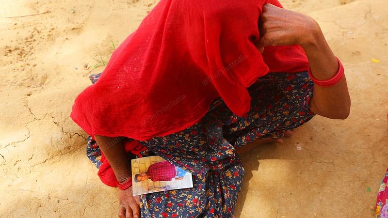 Gemra Ram Meghwal's mother Amku shows his photo, Barmer, Rajasthan | Manisha Mondal/ThePrint