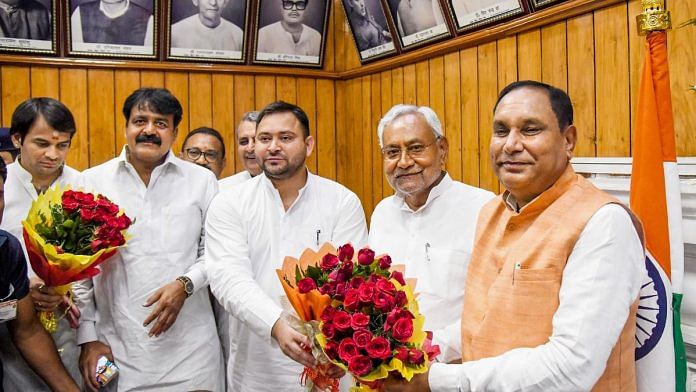 Bihar CM Nitish Kumar and Deputy CM Tejashwi Yadav greet acting Speaker Maheshwar Hazari during a special session of Bihar Legislative Assembly in Patna, on 24 August 2022 | PTI