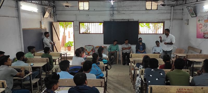 A workshop in session at the old campus of Savitri Jyotirao College of Social Work, Yavatmal while a frame of Bhimrao Ambedkar sits in front of the students | By special arrangement