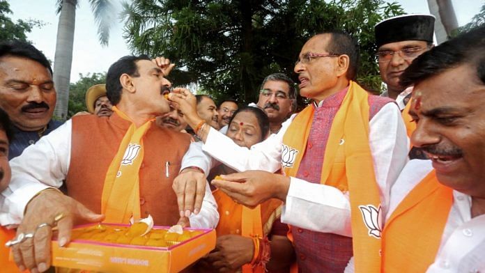File photo of Madhya Pradesh CM Shivraj Singh Chouhan and Home Minister Narottam Mishra celebrating BJP's win in civic elections | ANI