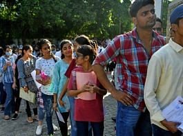 Aspirants wait in a queue to appear for CUET at a centre in Delhi | ANI file photo