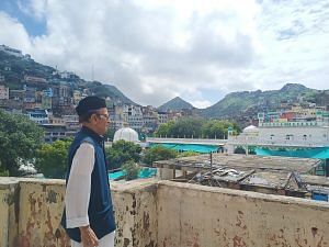 Haji Muqaddas Moini standing at the rooftop of his five-storey 'VIP house', with the view of Ajmer Dargah nestled in Aravalli hills in the background | Unnati Sharma | ThePrint