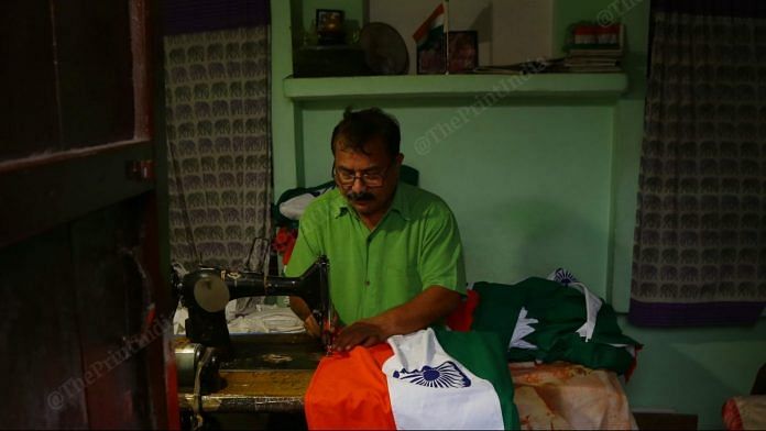 Ramesh Chandra stitches Khadi flags at his home in Meerut. | Photo Credit: Manisha Mondal