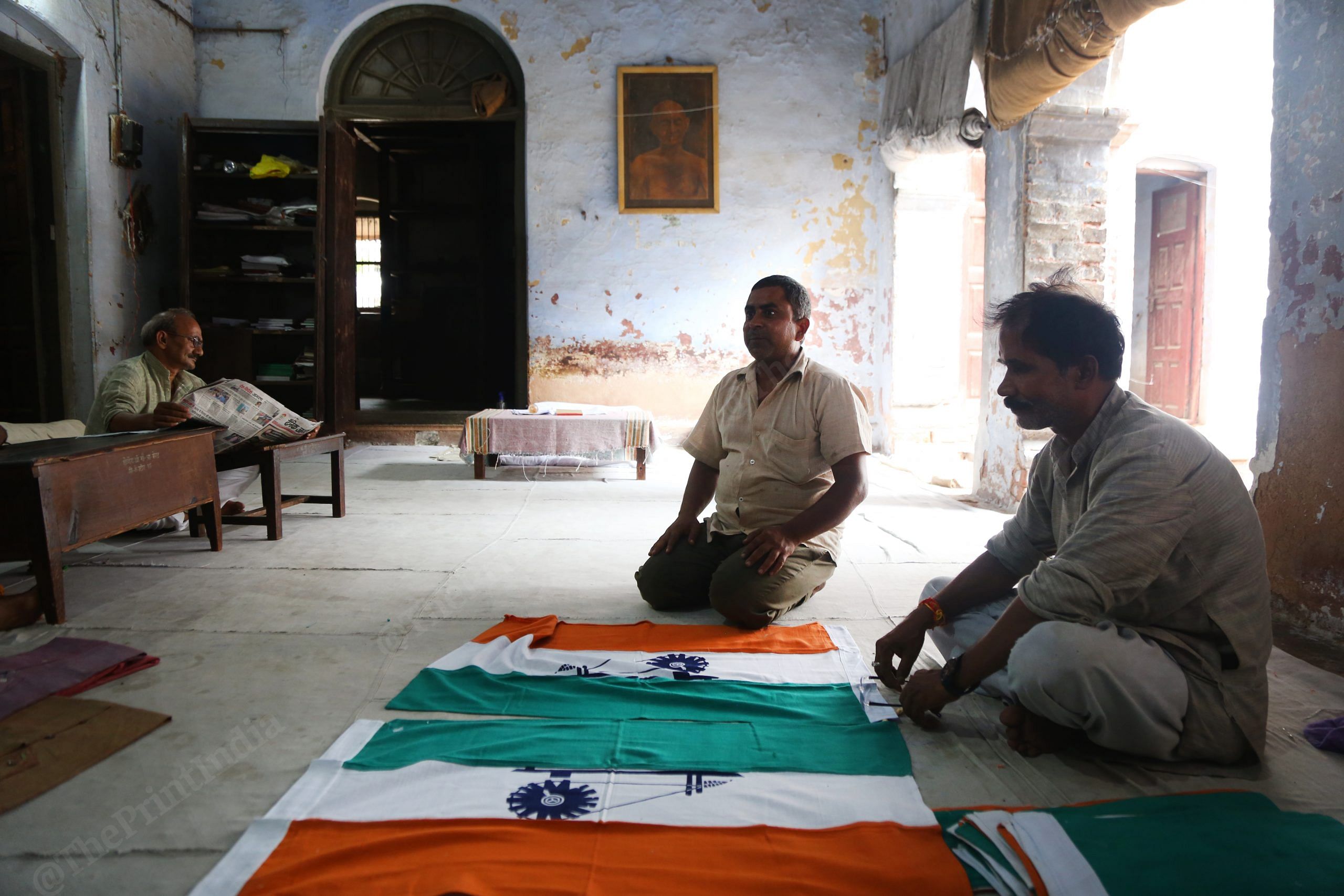 Workers selling flags with charkha at Gandhi Ashram in Meerut. | Photo Credit: Manisha Mondal