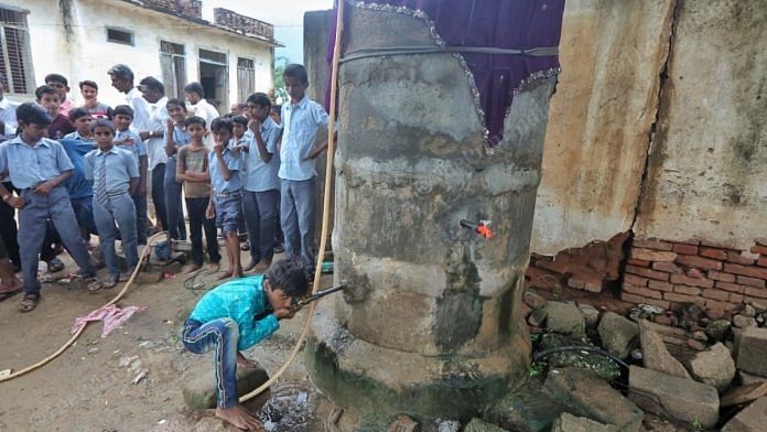 Students of Saraswati Vidya Mandir drinking water from the tank at Surana village | Praveen Jain | ThePrint
