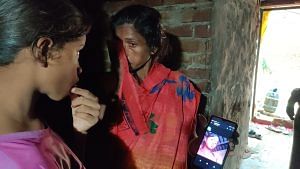 Mira Devi crying while showing Nisha’s photo on the phone. | Sonal Matharu, ThePrint