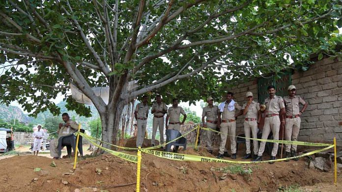 Police personnel stand guard by the banyan tree from which the body of Sant Ravinath was found hanging | Suraj Singh Bisht | ThePrint