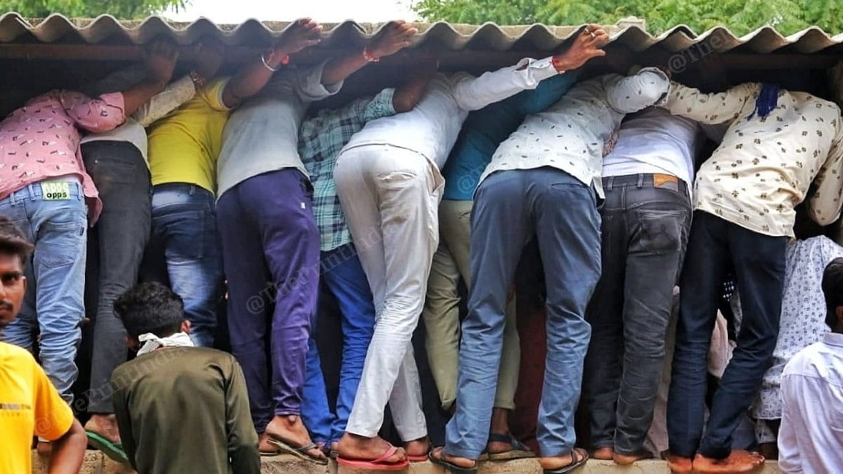 Crowds from surrounding villages try to listen in as boy's family argues with police officials | Praveen Jain | ThePrint
