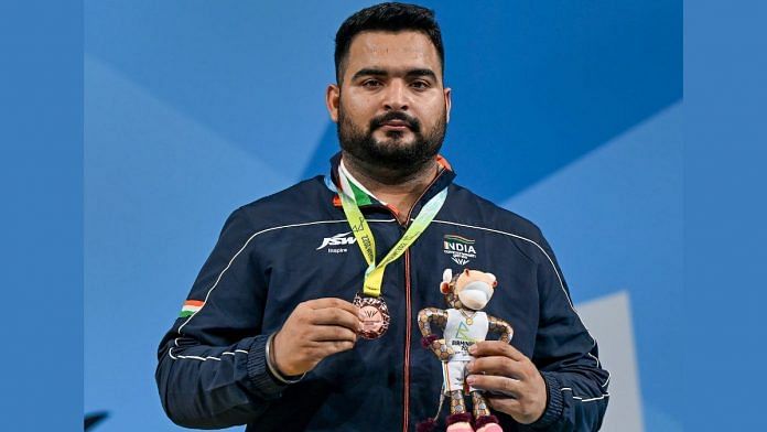 Lovepreet Singh poses for a photo after winning the bronze medal at the Commonwealth Games 2022, in Birmingham, UK, on 3 August 2022 | PTI