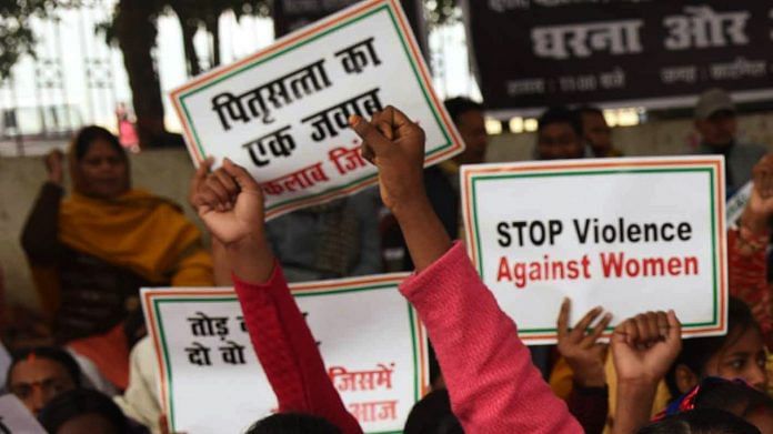 Protestors hold up placards to protest violence against women | Representational image | ANI