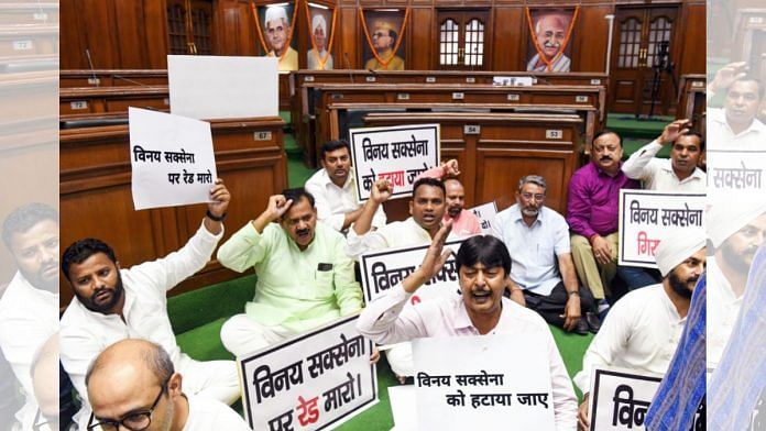 AAP MLAs holding placards raise slogans while staging a protest demanding resignation of Delhi L-G VK Saxena in New Delhi, on 29 August 2022 | ANI photo