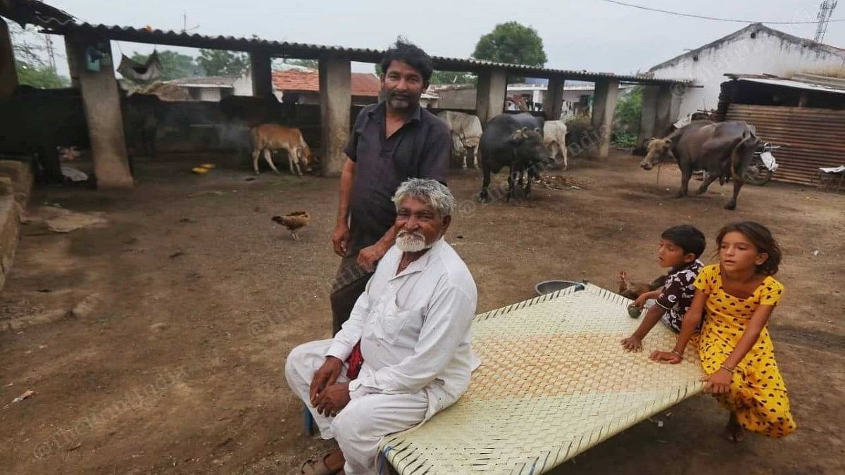 Kader Sher Mohammed Bhati with his family at their home in Mithi Rohar village. They have a calf suffering from lumpy skin disease, but haven't separated her from her healthy mother | Praveen Jain | ThePrint