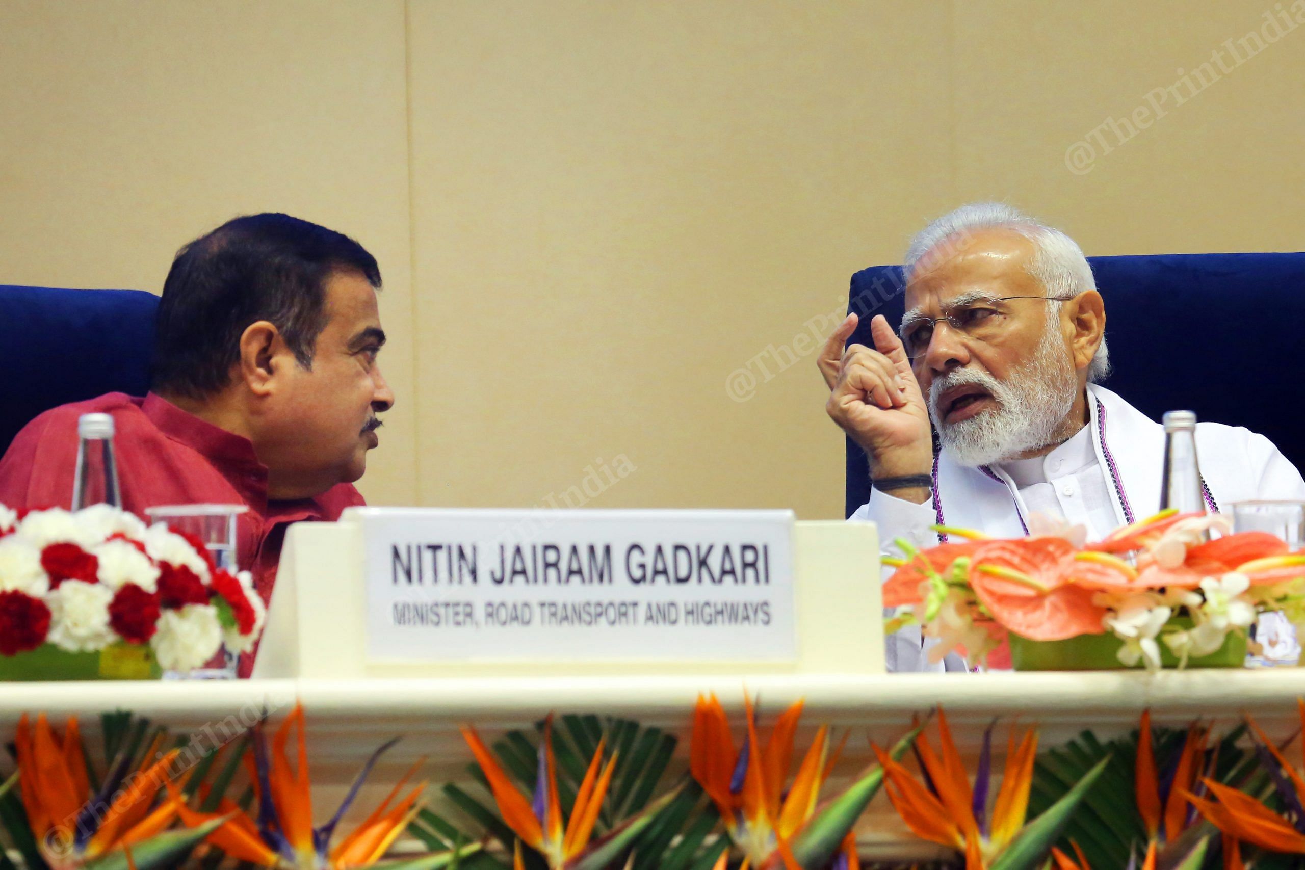 Prime Minister Narendra Modi talks to Nitin Gadkari during the event | Photo: Praveen Jain | ThePrint