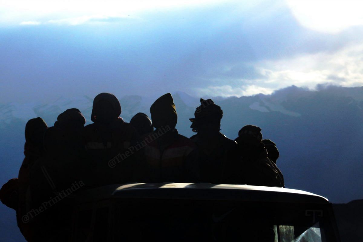 Construction workers climbing down the mountains to return to their tents | Praveen Jain | ThePrint