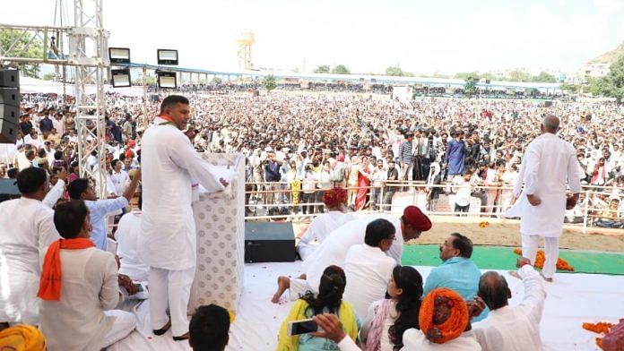 Rajasthan Minister Ashok Chandna addresses the crowd at the event Tuesday held for Gurjar leader Kirori Singh Bainsla in Pushkar | Twitter | @AshokChandnaINC